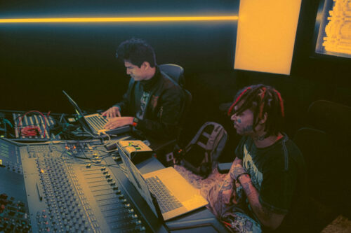 Photo of two musicians collaborating in a music studio