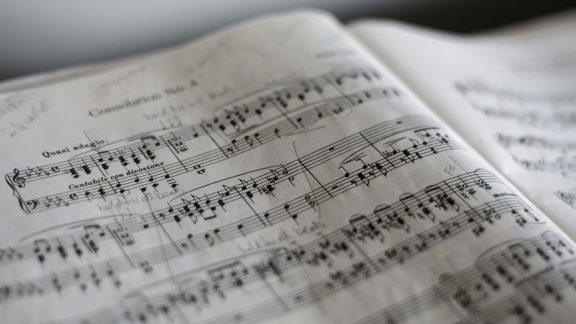 Photo of a book of sheet music depicting music theory